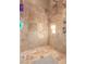 Large walk-in shower with tile surround and multiple shower heads at 18208 W Happy Valley Rd, Wittmann, AZ 85361