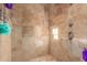 Large walk-in shower with neutral tile and multiple shower heads at 18208 W Happy Valley Rd, Wittmann, AZ 85361