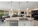 Granite kitchen island with seating overlooking living room at 21682 N 266Th Ave, Buckeye, AZ 85396