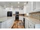 Modern kitchen with white cabinets, granite countertops, and stainless steel appliances at 234 S 73Rd Way, Mesa, AZ 85208