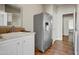 Laundry room with refrigerator, sink, and white cabinets at 234 S 73Rd Way, Mesa, AZ 85208