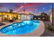 Inviting kidney-shaped pool with patio and string lights; perfect for entertaining at 2401 N 37Th St, Phoenix, AZ 85008