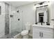 Modern bathroom with a white vanity, marble tile, and a glass shower at 2401 N 37Th St, Phoenix, AZ 85008