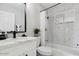 Clean bathroom with a bathtub, white vanity, and marble tile at 2401 N 37Th St, Phoenix, AZ 85008