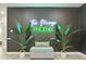Stylish entryway with a statement neon sign and lush plants at 2401 N 37Th St, Phoenix, AZ 85008