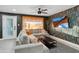 Living room with a cactus-themed wall and sectional sofa at 2401 N 37Th St, Phoenix, AZ 85008