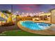 Night view of a refreshing pool, surrounded by patio furniture at 2401 N 37Th St, Phoenix, AZ 85008