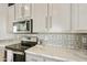 Modern kitchen with stainless steel appliances and patterned backsplash at 2929 E Main St # 128, Mesa, AZ 85213