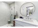 Modern bathroom featuring a round mirror and marble vanity at 3815 E Berridge Ln, Paradise Valley, AZ 85253