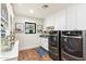 Laundry room with front load washer and dryer and custom cabinetry at 3815 E Berridge Ln, Paradise Valley, AZ 85253