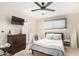 Spacious bedroom with a double bed, dresser, and ceiling fan at 4937 N Granite Reef Rd, Scottsdale, AZ 85251