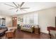 Living room with a green couch, dark wood floors, and ceiling fan at 4937 N Granite Reef Rd, Scottsdale, AZ 85251