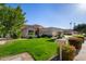 House exterior with lush lawn and two-car garage at 13918 W Summerstar Dr, Sun City West, AZ 85375