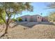 View of the home's exterior and backyard with gravel and stone accents at 18548 E Parada Cir, Rio Verde, AZ 85263