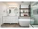 Elegant bathroom with soaking tub, double vanity, and floating shelves at 2156 E Vista Bonita Dr, Phoenix, AZ 85024