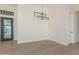 Bright dining area with hardwood floors and modern light fixture at 22378 W Daley Ln, Surprise, AZ 85387