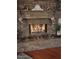 Stone fireplace with a burning fire, mantle, and holiday stockings at 29224 N 146Th St, Scottsdale, AZ 85262