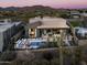 Aerial view of a luxury home with a pool and mountain views at 37200 N Cave Creek Rd # 1036, Scottsdale, AZ 85262