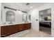 Bathroom with double vanity and view into bedroom at 5322 N Oro Vista Ct, Litchfield Park, AZ 85340