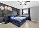 Main bedroom with a large bed, ceiling fan, and floral wall art at 618 N Stapley Dr, Mesa, AZ 85203