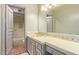 Bathroom with a tiled vanity, sink, and access to a shower at 7500 E Mccormick Pkwy # 29, Scottsdale, AZ 85258