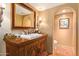 Elegant bathroom with a white sink, wooden vanity, and a tiled floor at 7500 E Mccormick Pkwy # 29, Scottsdale, AZ 85258