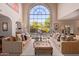 Bright living room with large arched windows overlooking the pool at 7500 E Mccormick Pkwy # 29, Scottsdale, AZ 85258