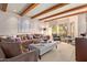 Spacious living room with wood-beam ceilings, comfortable seating, and large windows at 7500 E Mccormick Pkwy # 29, Scottsdale, AZ 85258