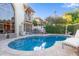 Inviting kidney-shaped pool with a patio and lounge chair in a lush backyard setting at 7500 E Mccormick Pkwy # 29, Scottsdale, AZ 85258