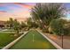 Landscaped backyard with a dedicated bocce ball court at 8848 E Via Del Sol Dr, Scottsdale, AZ 85255