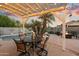 Charming patio with pergola, string lights, and a dining table, ideal for outdoor meals at 913 N John Way, Chandler, AZ 85225