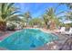 Relaxing kidney shaped pool surrounded by palm trees at 14264 S Baniff Ln, Arizona City, AZ 85123