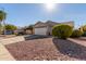 Front view of house with a two-car garage and driveway at 15351 W Port Royale Ln, Surprise, AZ 85379