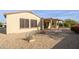 Backyard view showing home's exterior and covered patio at 16933 W Oasis Springs Way, Surprise, AZ 85387
