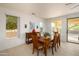 Bright dining area with wooden table and access to backyard at 16933 W Oasis Springs Way, Surprise, AZ 85387