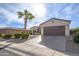 Exterior view of house and garage with landscaping at 16933 W Oasis Springs Way, Surprise, AZ 85387