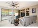 Spacious living area with large windows and access to patio at 16933 W Oasis Springs Way, Surprise, AZ 85387