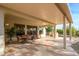 Covered patio with seating area and view of backyard at 16933 W Oasis Springs Way, Surprise, AZ 85387