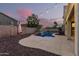 Inviting backyard with pool, patio, and string lights at 17881 W Larkspur Dr, Surprise, AZ 85388