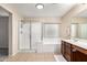 Main bathroom with shower, tub, and double vanity at 17881 W Larkspur Dr, Surprise, AZ 85388