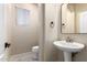 Modern bathroom with pedestal sink and updated fixtures at 17881 W Larkspur Dr, Surprise, AZ 85388