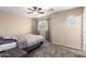 Comfortable bedroom with ceiling fan and window coverings at 17881 W Larkspur Dr, Surprise, AZ 85388