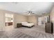 Secondary bedroom with ceiling fan and ample closet space at 17881 W Larkspur Dr, Surprise, AZ 85388