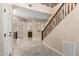 Bright and spacious entryway with a grand staircase and tile flooring at 17881 W Larkspur Dr, Surprise, AZ 85388