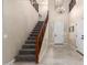 Bright and spacious entryway with a grand staircase and tile flooring at 17881 W Larkspur Dr, Surprise, AZ 85388