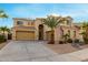 Two-story house with tan exterior, palm trees, and a three-car garage at 17881 W Larkspur Dr, Surprise, AZ 85388