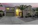 Two-story house with a landscaped yard, large windows, and a three-car garage at 17881 W Larkspur Dr, Surprise, AZ 85388