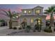 Two-story house with a landscaped yard, large windows, and a three-car garage at 17881 W Larkspur Dr, Surprise, AZ 85388
