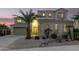 Two-story house with a landscaped yard, large windows, and a three-car garage at 17881 W Larkspur Dr, Surprise, AZ 85388