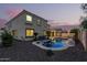 Two-story house with a backyard pool and patio, perfect for summer evenings at 17881 W Larkspur Dr, Surprise, AZ 85388